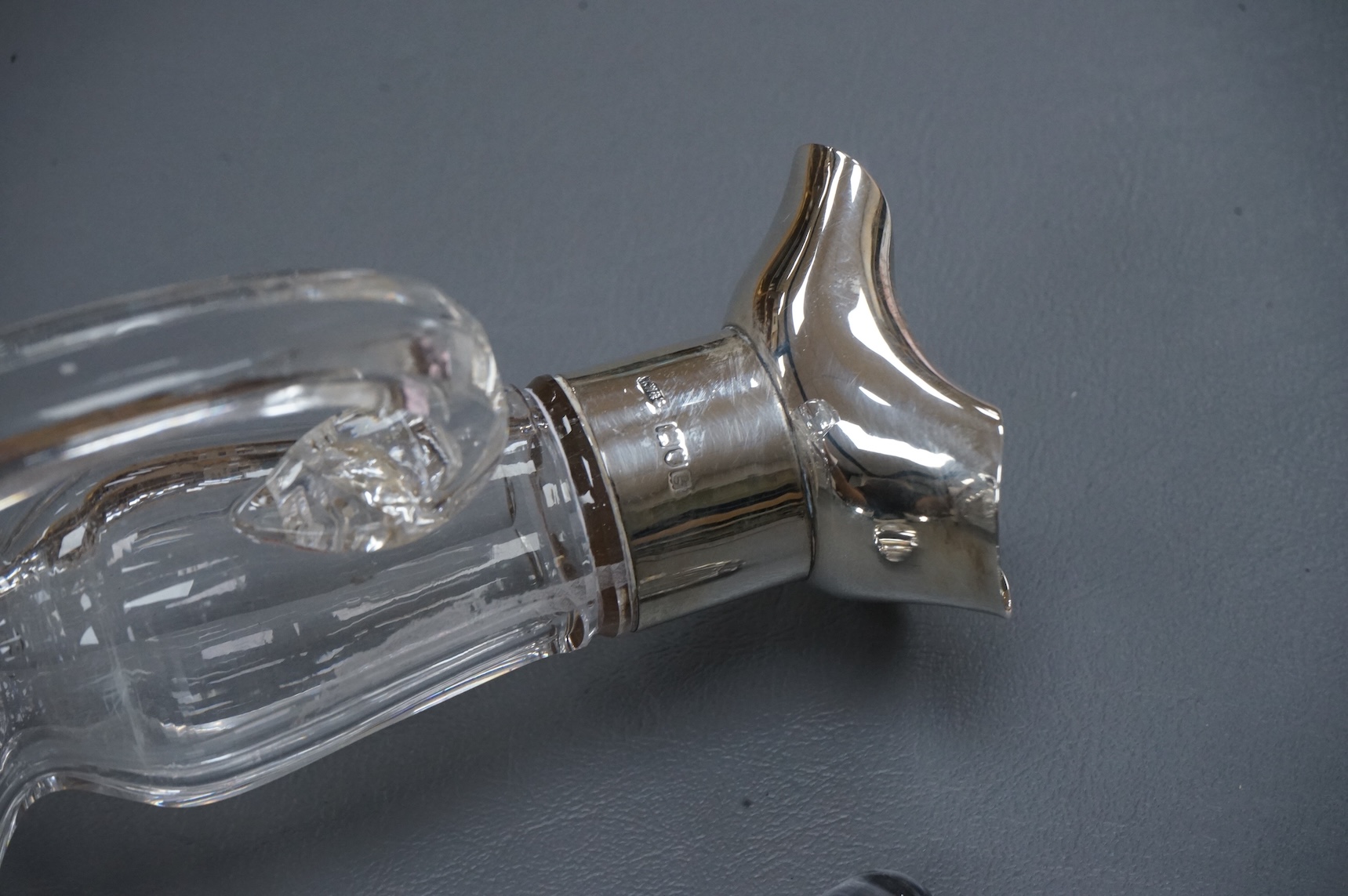 An Edwardian silver mounted cut glass bell shaped single handled decanter, with stopper, by Thomas Webb & Sons Ltd, London, 1902, 34.2cm.